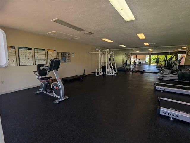 exercise room with a textured ceiling