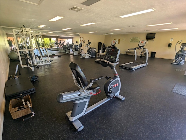 exercise room with a textured ceiling