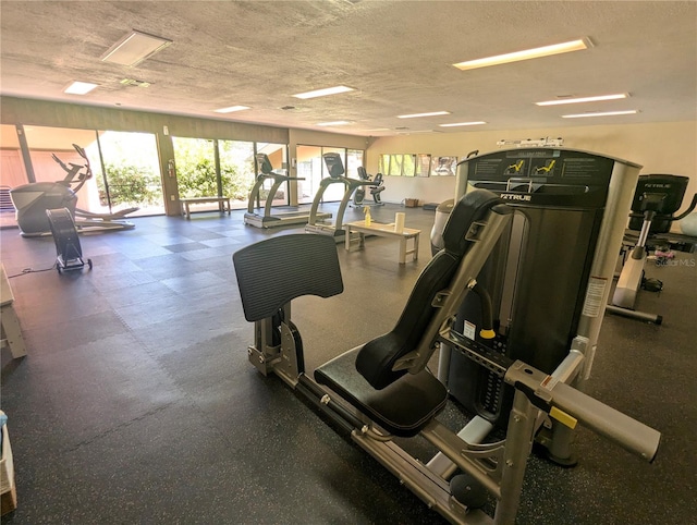 exercise room with a textured ceiling