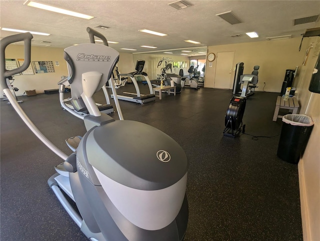 gym featuring a textured ceiling