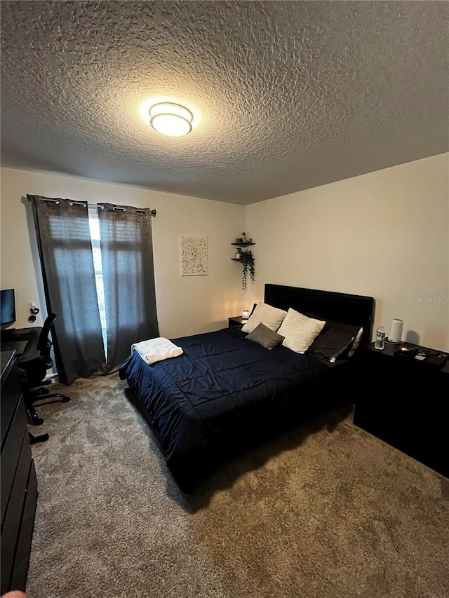 bedroom featuring a textured ceiling and carpet floors