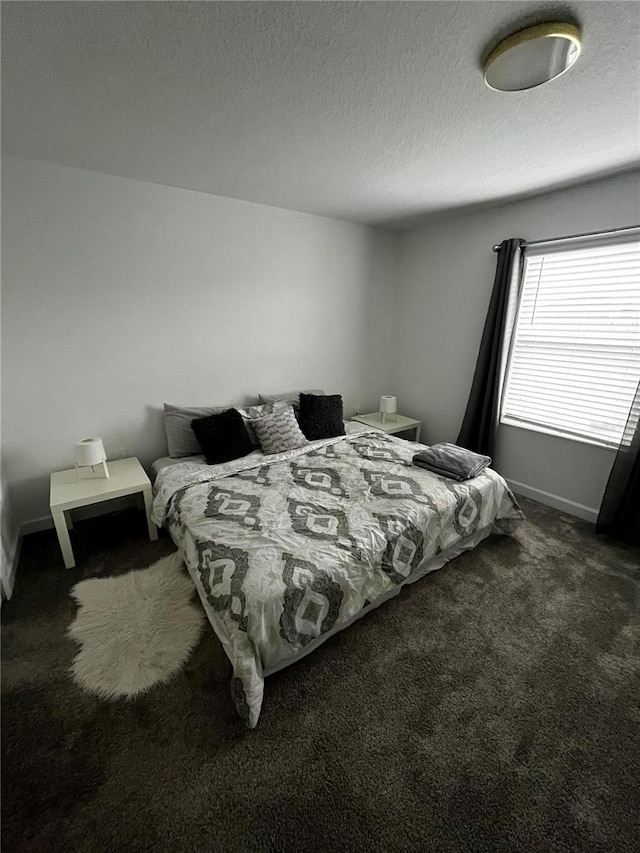 carpeted bedroom with a textured ceiling