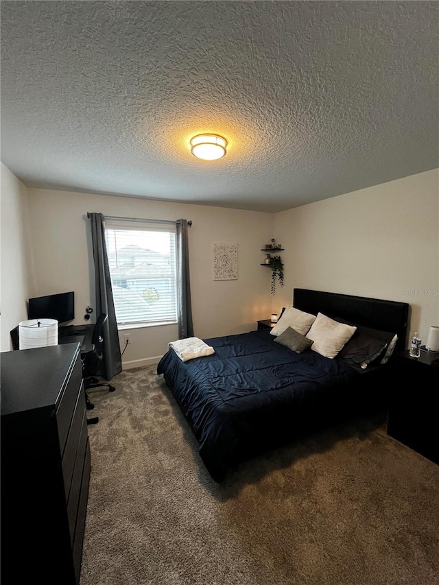 carpeted bedroom featuring a textured ceiling