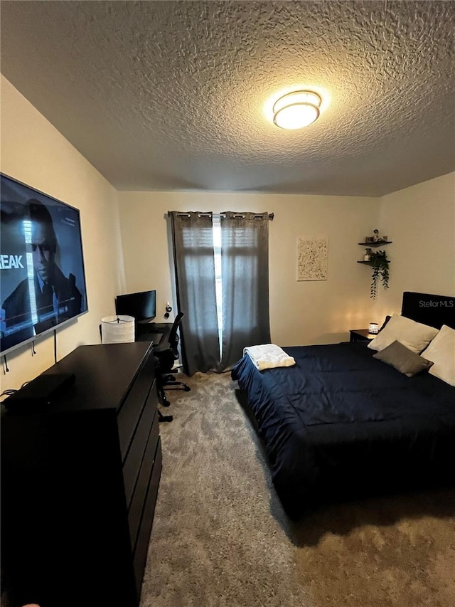 bedroom featuring a textured ceiling and carpet floors