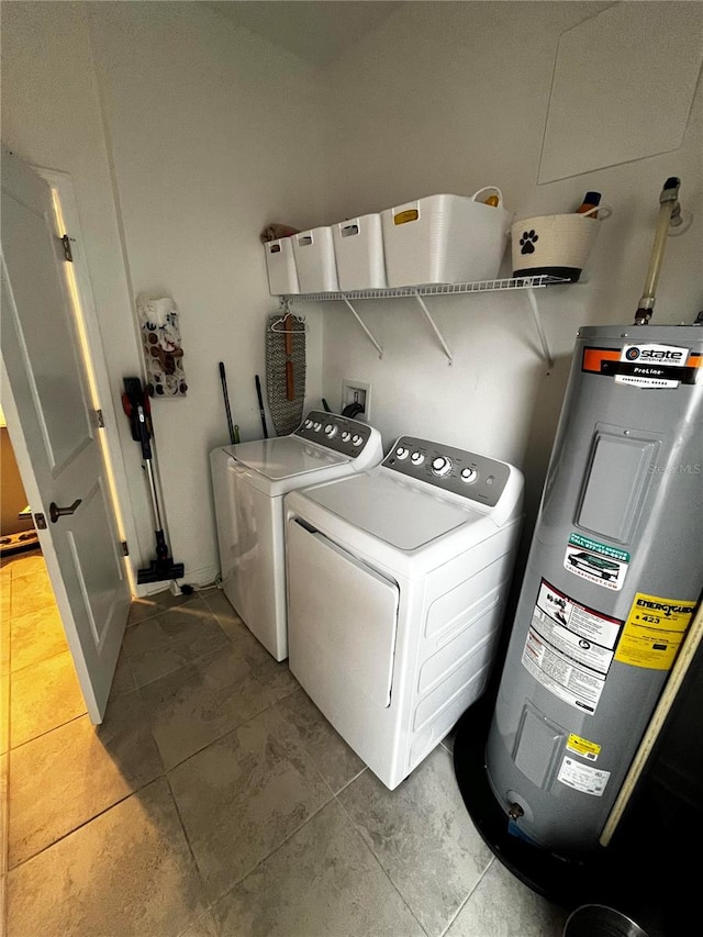 laundry area featuring water heater, separate washer and dryer, and tile patterned floors