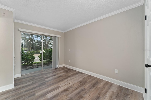 unfurnished room with a textured ceiling, dark hardwood / wood-style floors, and ornamental molding