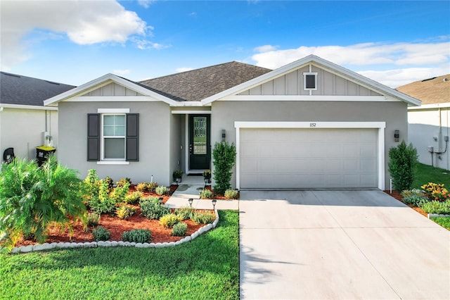 view of front of home featuring a front yard and a garage