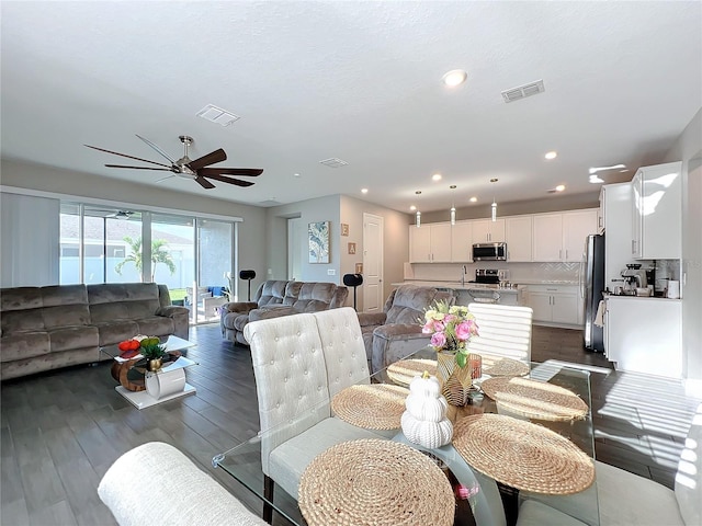 dining area featuring dark hardwood / wood-style flooring and ceiling fan