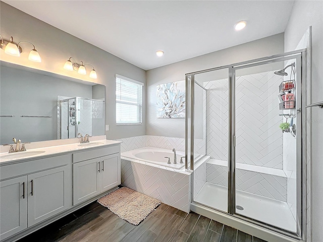 bathroom with shower with separate bathtub, vanity, and hardwood / wood-style flooring