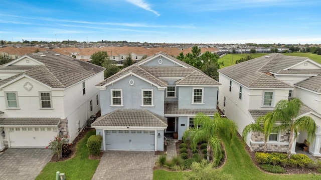 1536 Maidstone Ct, Davenport, FL 33896 - traditional-style home featuring a garage, stucco siding, a tile roof, a residential view, and driveway