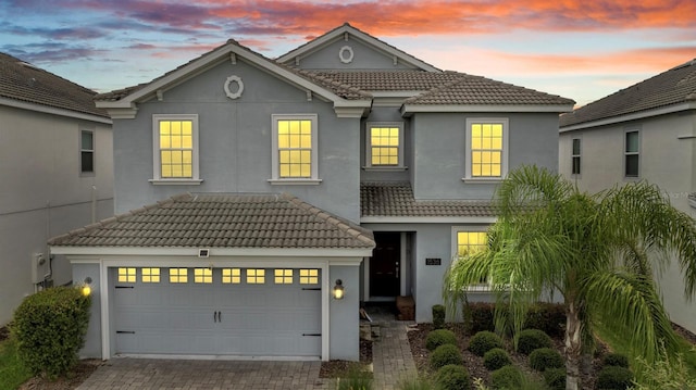 1536 Maidstone Ct, Davenport, FL 33896 - view of front of house with a tiled roof, driveway, stucco siding, and an attached garage