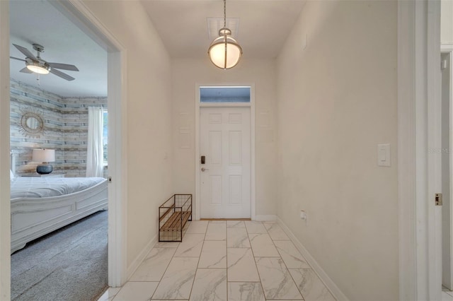 foyer entrance with ceiling fan