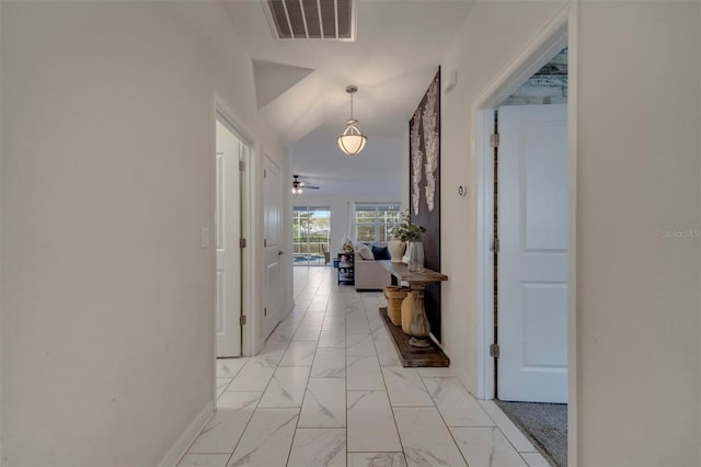 corridor with vaulted ceiling