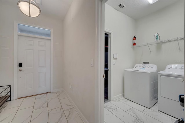 clothes washing area featuring independent washer and dryer