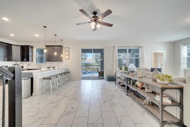 living room with ceiling fan and sink