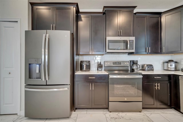 kitchen featuring appliances with stainless steel finishes, decorative backsplash, and dark brown cabinetry