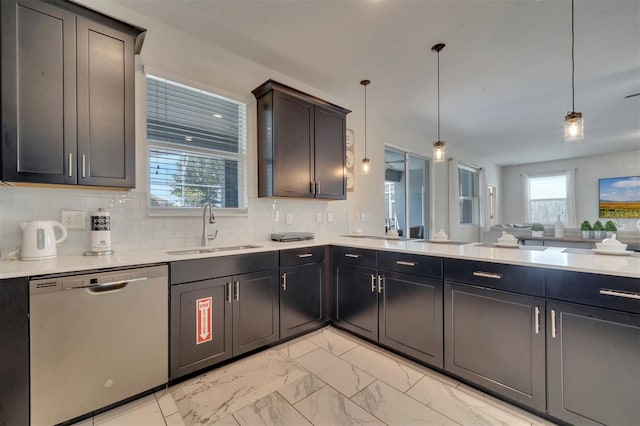 kitchen featuring dark brown cabinets, dishwasher, tasteful backsplash, sink, and decorative light fixtures