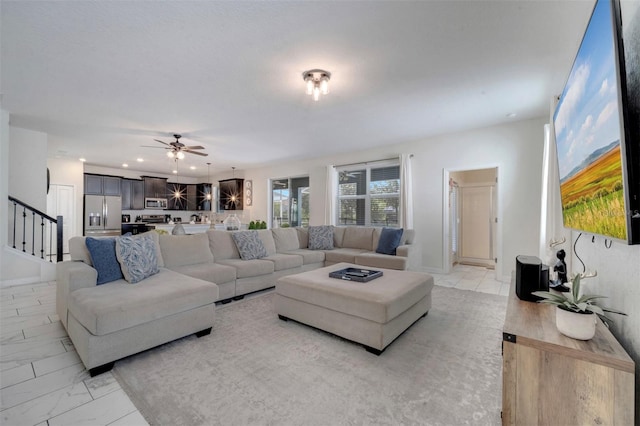 1536 Maidstone Ct, Davenport, FL 33896 - living room featuring marble finish floor, baseboards, ceiling fan, and stairway