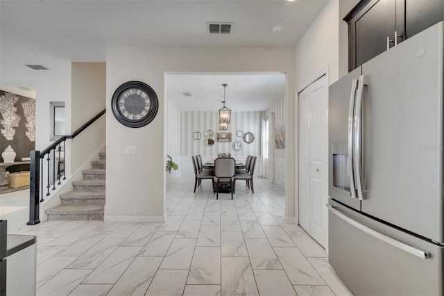 kitchen featuring hanging light fixtures and stainless steel refrigerator with ice dispenser