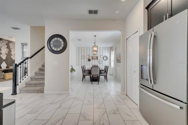 1536 Maidstone Ct, Davenport, FL 33896 - unfurnished dining area with marble finish floor, visible vents, stairs, and an inviting chandelier