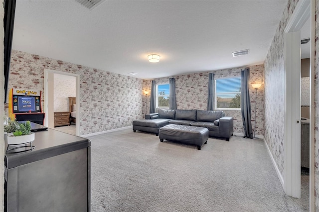 living room featuring light carpet and a textured ceiling