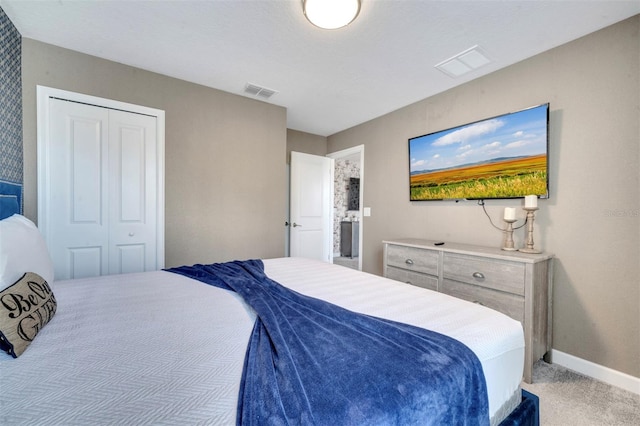 bedroom featuring light carpet and a closet