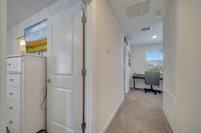 corridor featuring light colored carpet