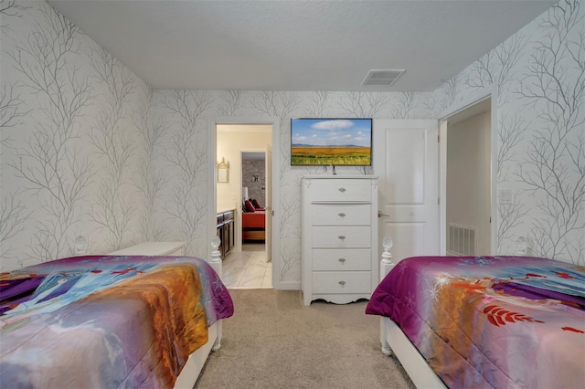 carpeted bedroom featuring connected bathroom