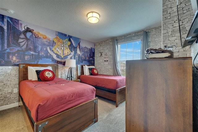 bedroom featuring a textured ceiling and light colored carpet