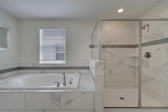 bathroom featuring shower with separate bathtub