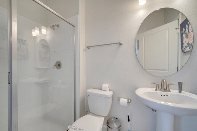 1536 Maidstone Ct, Davenport, FL 33896 - bathroom featuring a stall shower, toilet, and a sink
