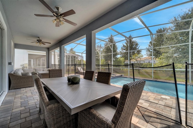 sunroom / solarium featuring ceiling fan