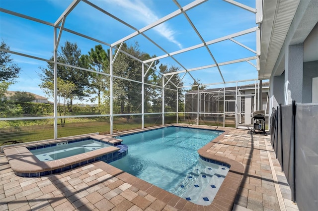 view of swimming pool with an in ground hot tub, grilling area, glass enclosure, and a patio