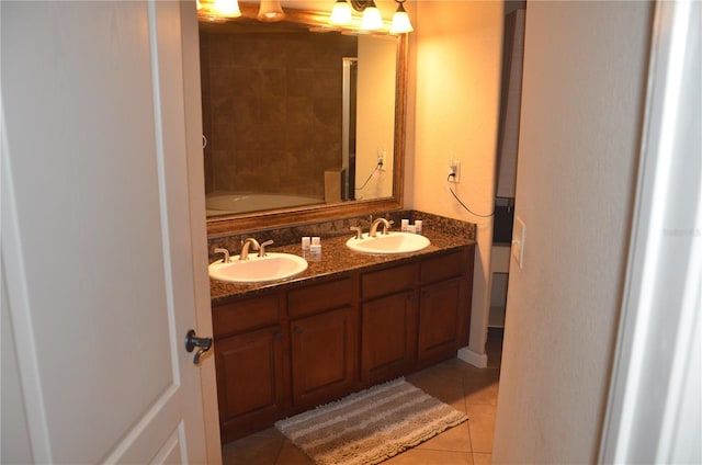 bathroom with vanity, a tub to relax in, and tile patterned flooring