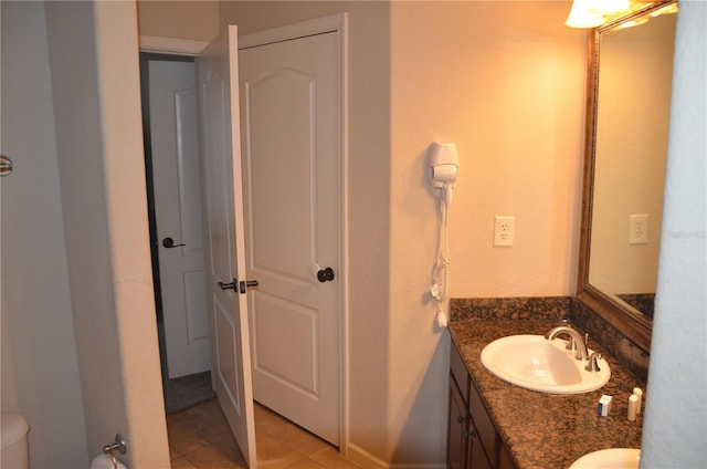 bathroom with vanity, tile patterned flooring, and toilet