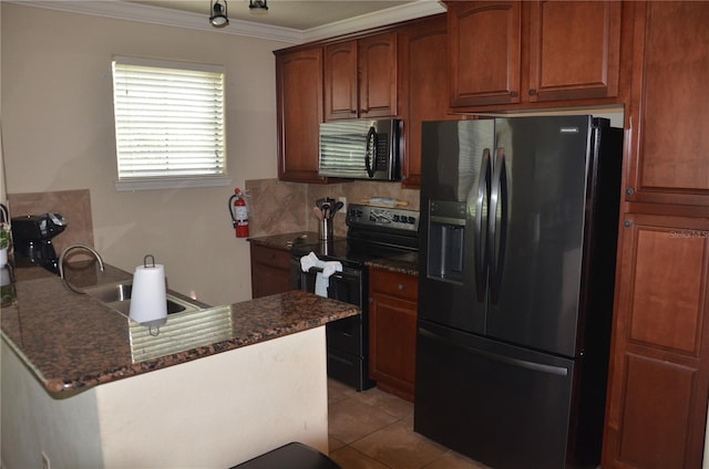 kitchen with tasteful backsplash, sink, black appliances, light tile patterned floors, and dark stone countertops