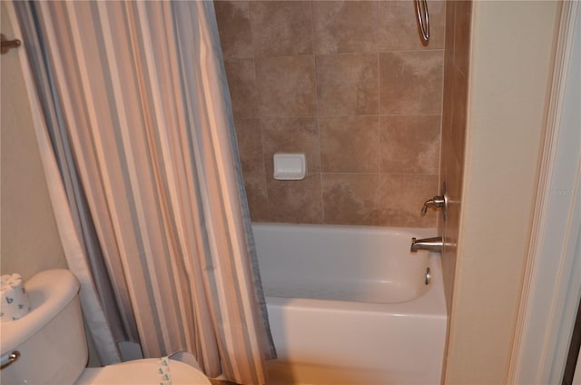 bathroom with shower / bath combo and toilet