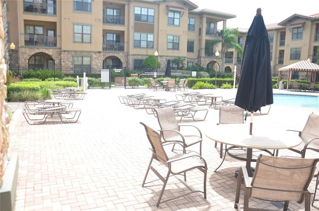 view of swimming pool featuring a patio area and a gazebo