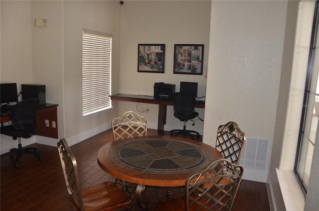 home office with dark hardwood / wood-style flooring