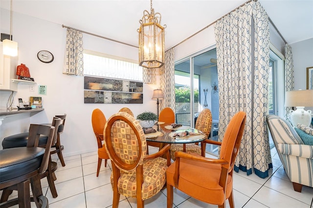 dining space with an inviting chandelier and light tile patterned flooring