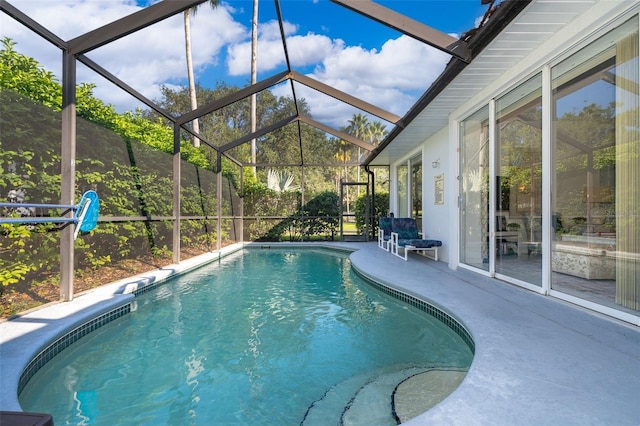 view of pool with a patio and a lanai