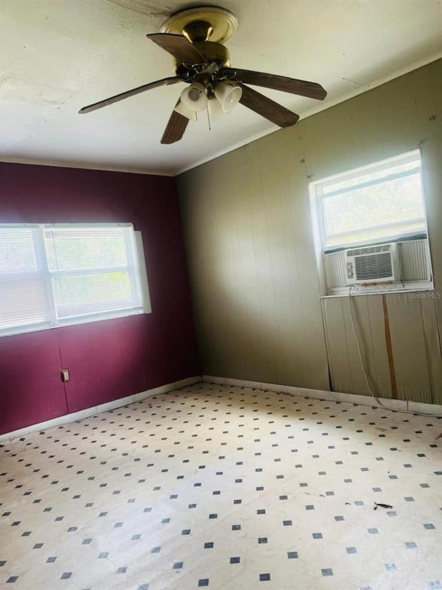 empty room featuring ceiling fan, cooling unit, and wood walls