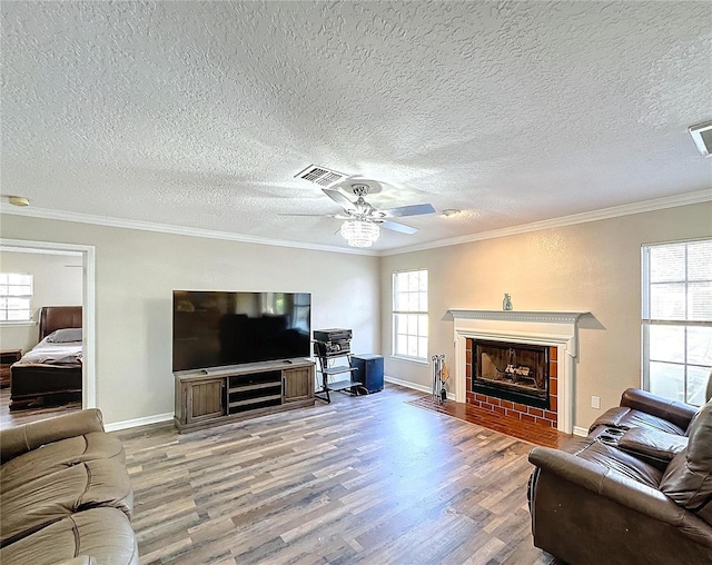 living room featuring ceiling fan, ornamental molding, and wood-type flooring