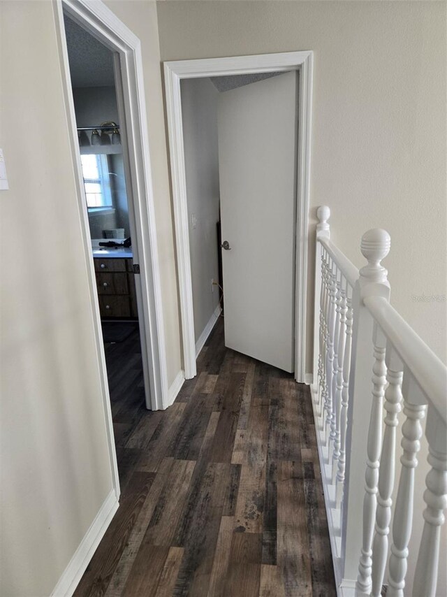 hallway with dark hardwood / wood-style floors