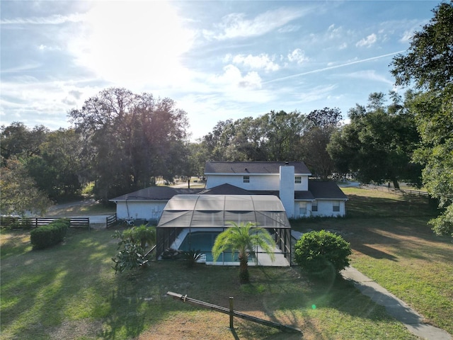 back of property with an outbuilding and a lawn