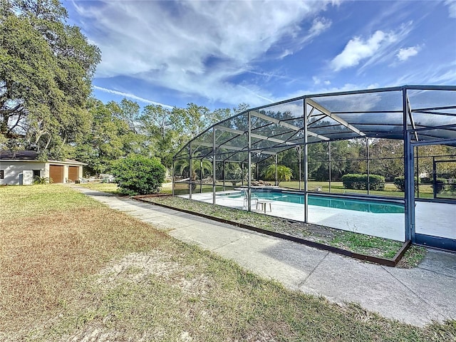 view of swimming pool featuring a lanai and a yard