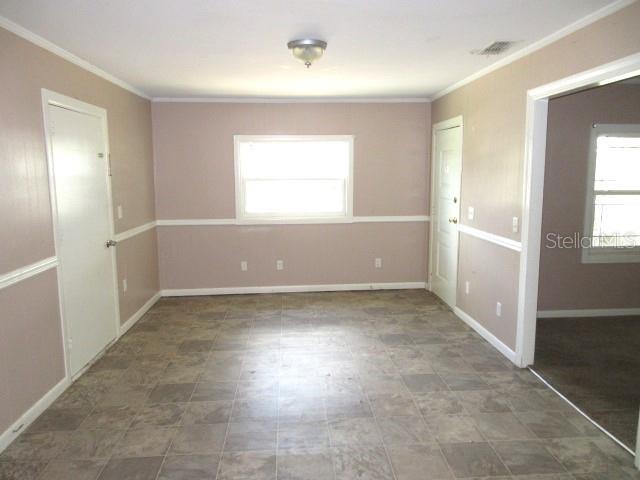 empty room featuring ornamental molding