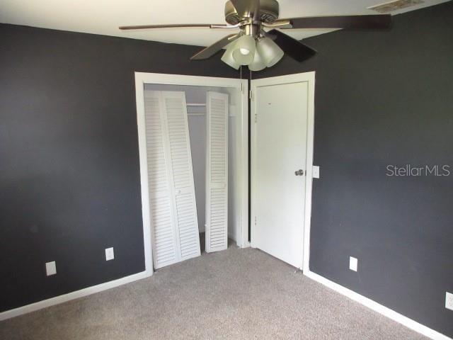 unfurnished bedroom featuring carpet and ceiling fan