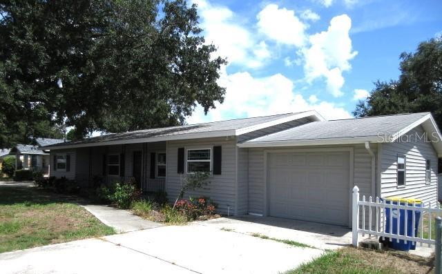 ranch-style house featuring fence, a garage, and concrete driveway