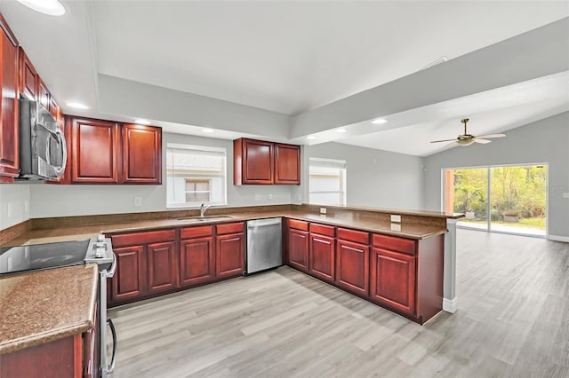 kitchen featuring appliances with stainless steel finishes, light hardwood / wood-style floors, lofted ceiling, ceiling fan, and sink